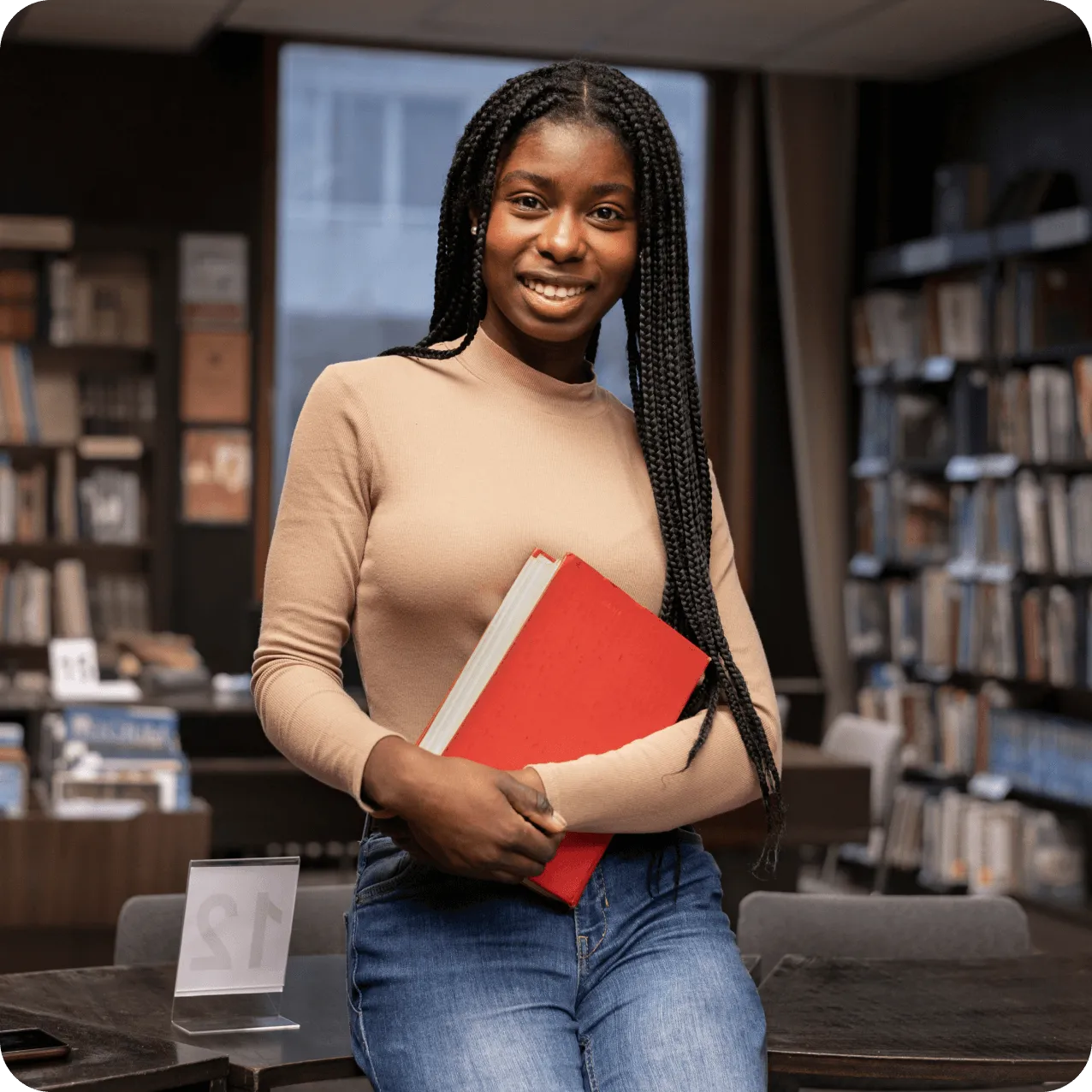 A girl holding a book in a library